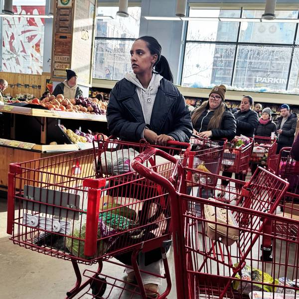 Shoppers wait in line at a grocery store in Washington, DC on January 23, 2026. 