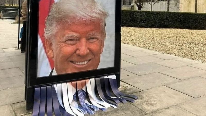 Shredded image of Trump on UK bus stop.