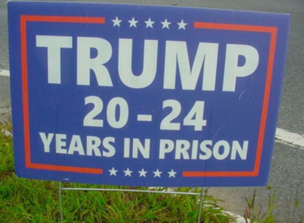 Sign calling for Trump to serve 20 to 24 years in prison.
