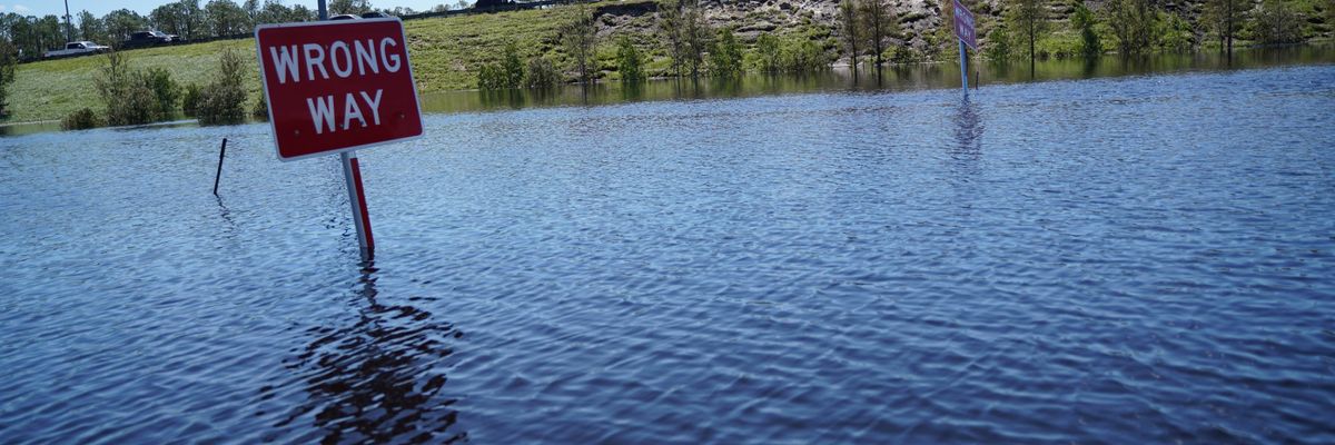 sign in flooded Florida reads 'wrong way'