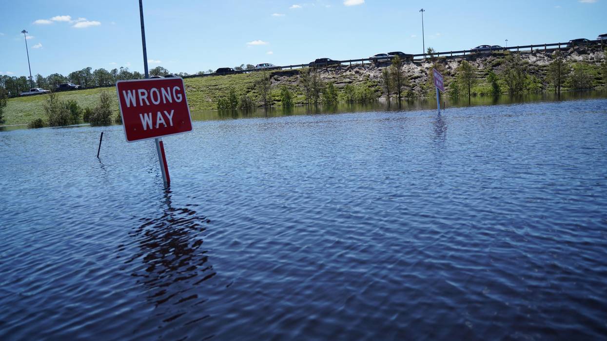 sign in flooded Florida reads 'wrong way'