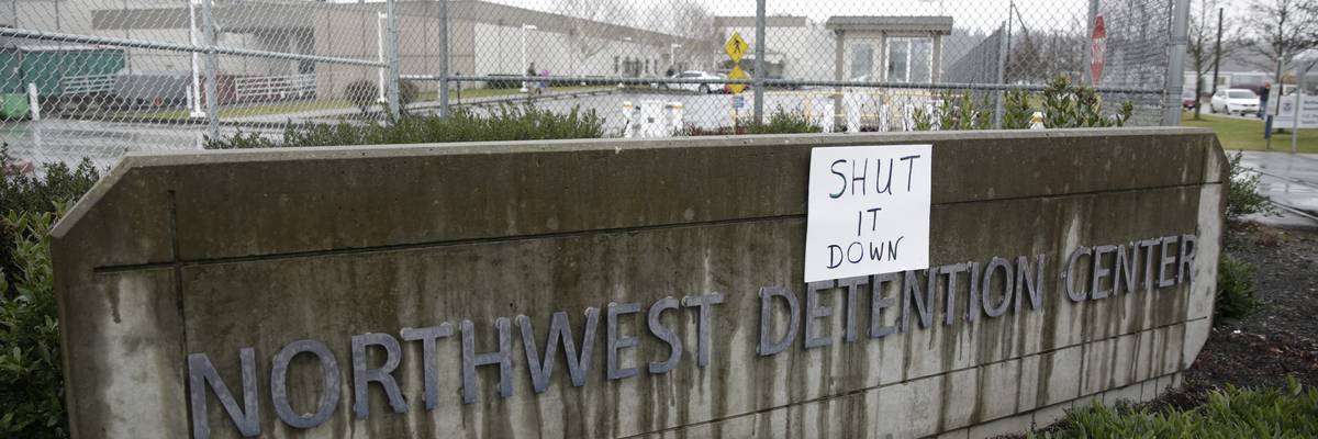 Sign protesting immigration detention center.