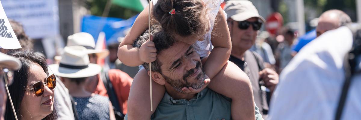 Sign reading "PEACE" at NATO protest in Madrid