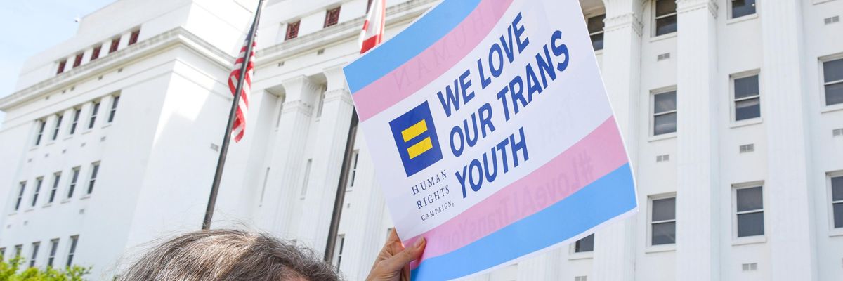 Sign reading "We love our trans youth"