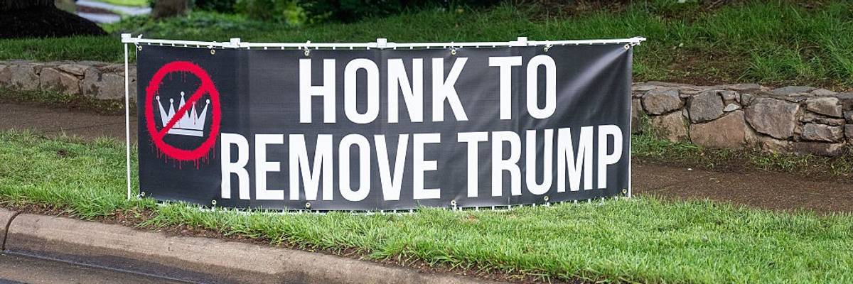 Sign reads Honk to Remove Trump