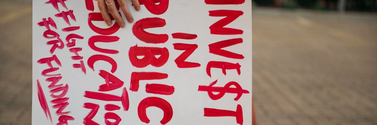 Sign reads "Invest in Public Education"