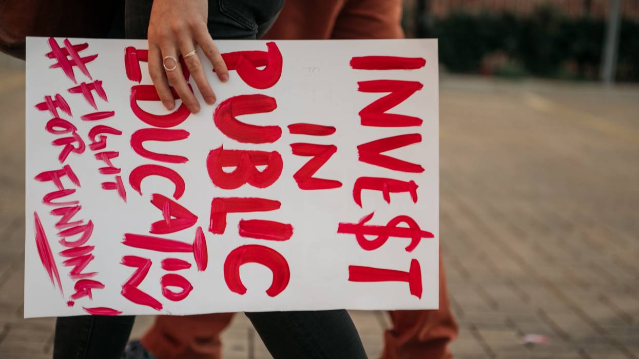 Sign reads "Invest in Public Education"