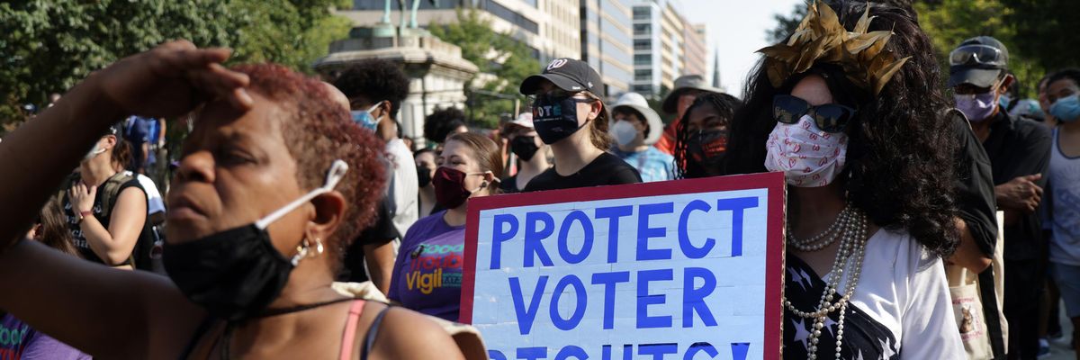 Sign reads "Protect Voting Rights"