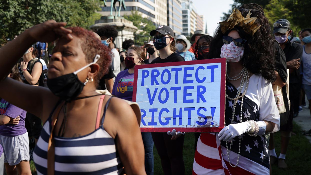 Sign reads "Protect Voting Rights"