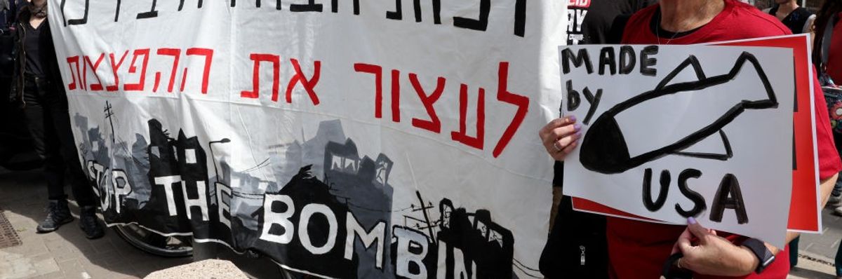 Sign reads "Stop the Bombing" of Gaza / Bombs "Made by USA"