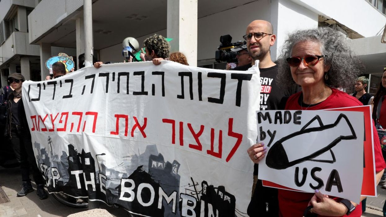 Sign reads "Stop the Bombing" of Gaza / Bombs "Made by USA"
