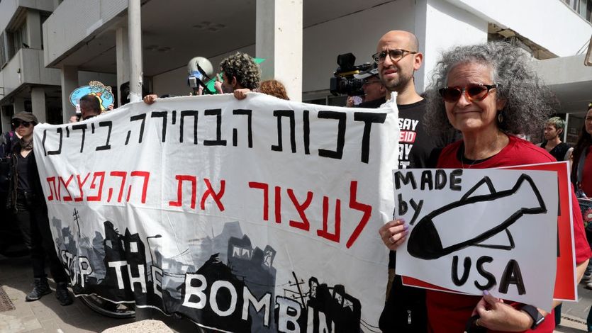 Sign reads "Stop the Bombing" of Gaza / Bombs "Made by USA"