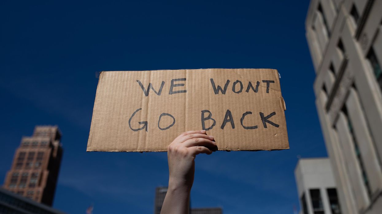 Sign reads "We Won't Go Back," a reference to abortion rights.