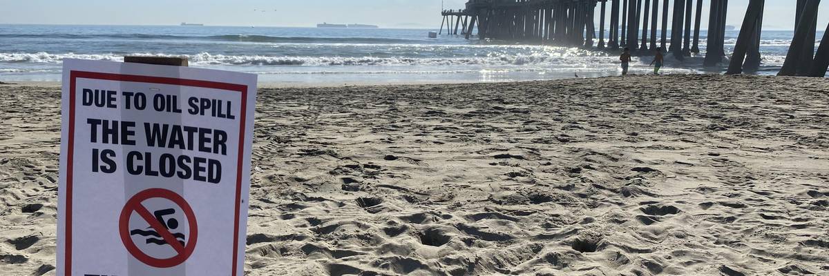 Sign saying water is closed due to oil spill