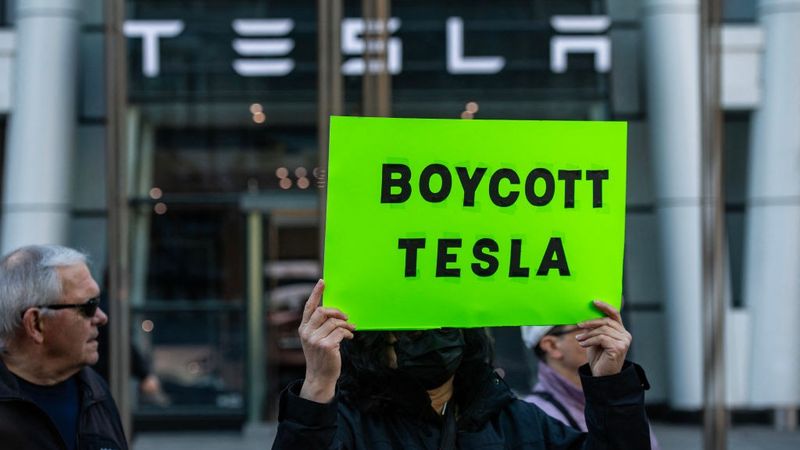Sign says "Boycott Tesla"