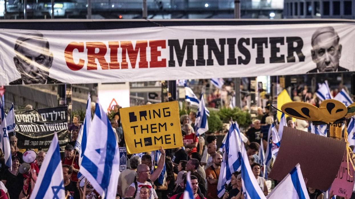 Sign says "Crime Minister" with picture of Prime Minister Netanyahu
