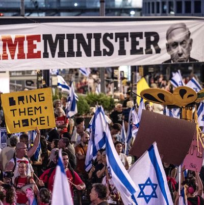 Sign says "Crime Minister" with picture of Prime Minister Netanyahu