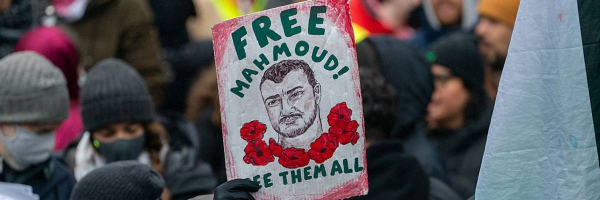 Sign says: "Free Mahmoud! Free Them All"