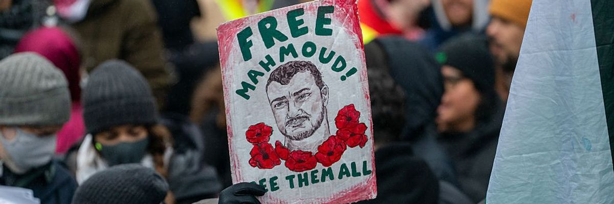 Sign says: "Free Mahmoud! Free Them All"