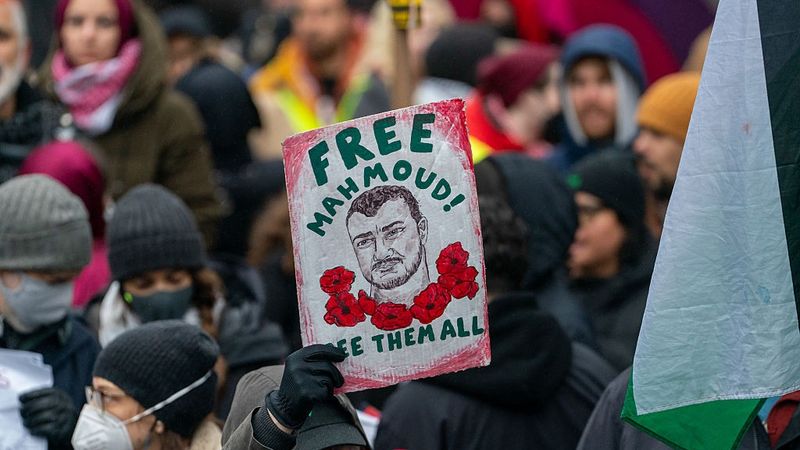 Sign says: "Free Mahmoud! Free Them All"