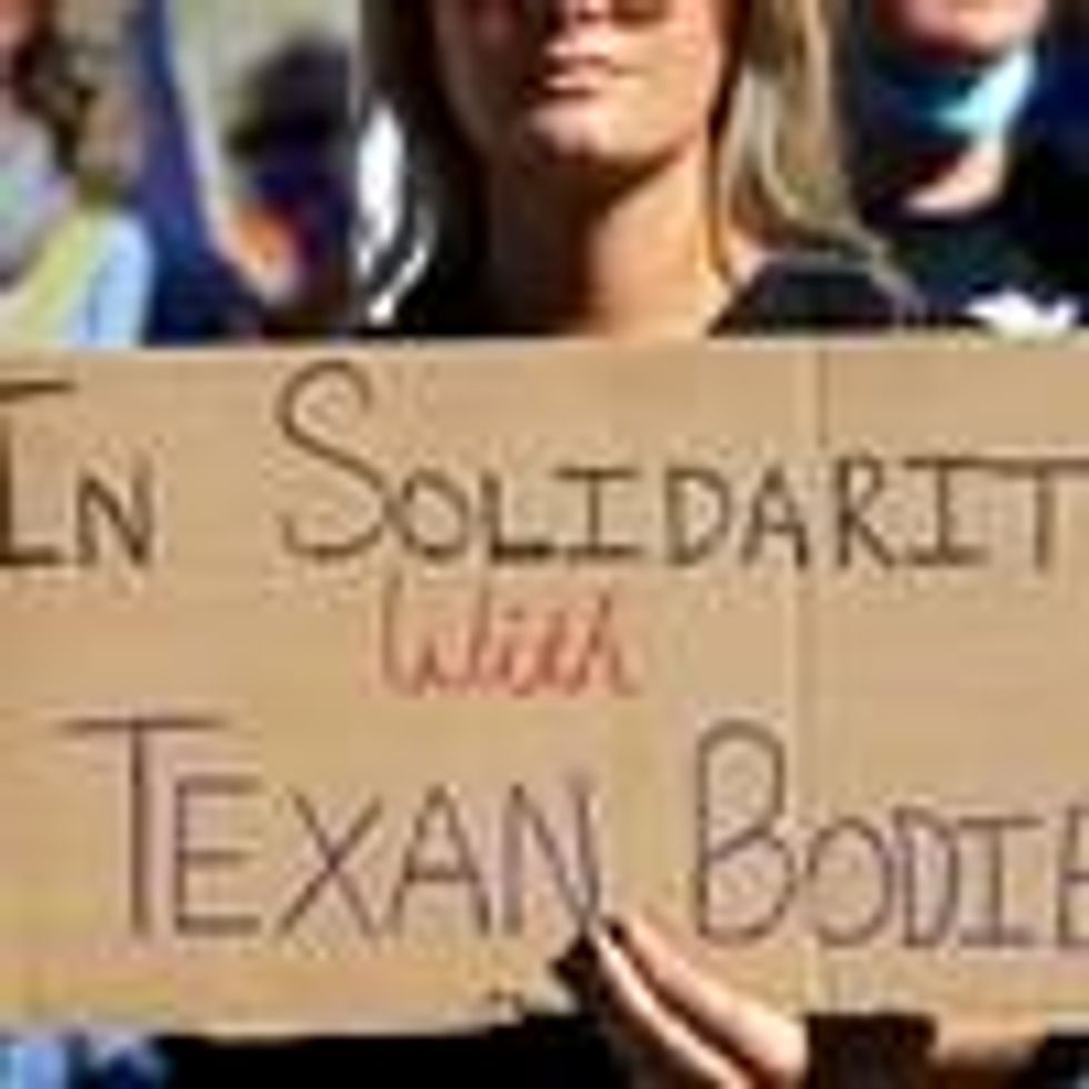 Sign says in solidarity with Texan bodies