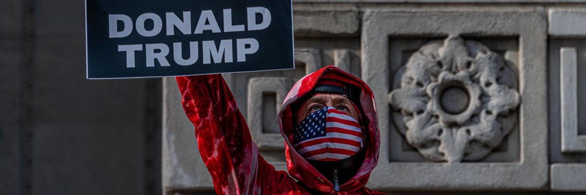 sign says INDICT DONALD TRUMP