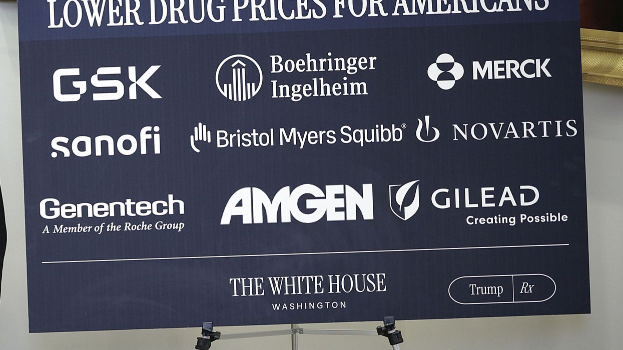 sign says lowering drug prices for americans with pharaceutical company logos