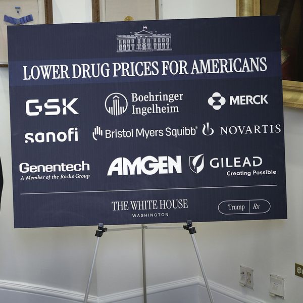 sign says lowering drug prices for americans with pharaceutical company logos