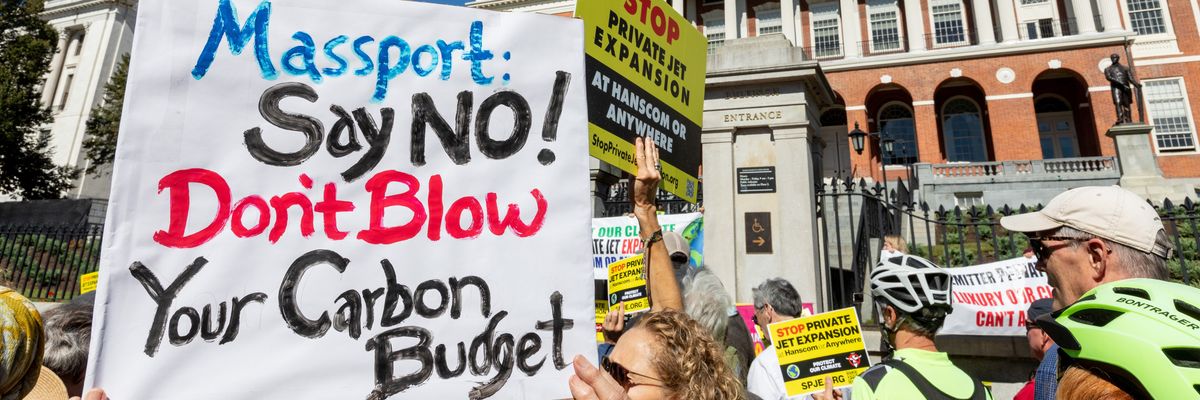 Sign says "Massport: Say No! Don't blow your carbon budget"