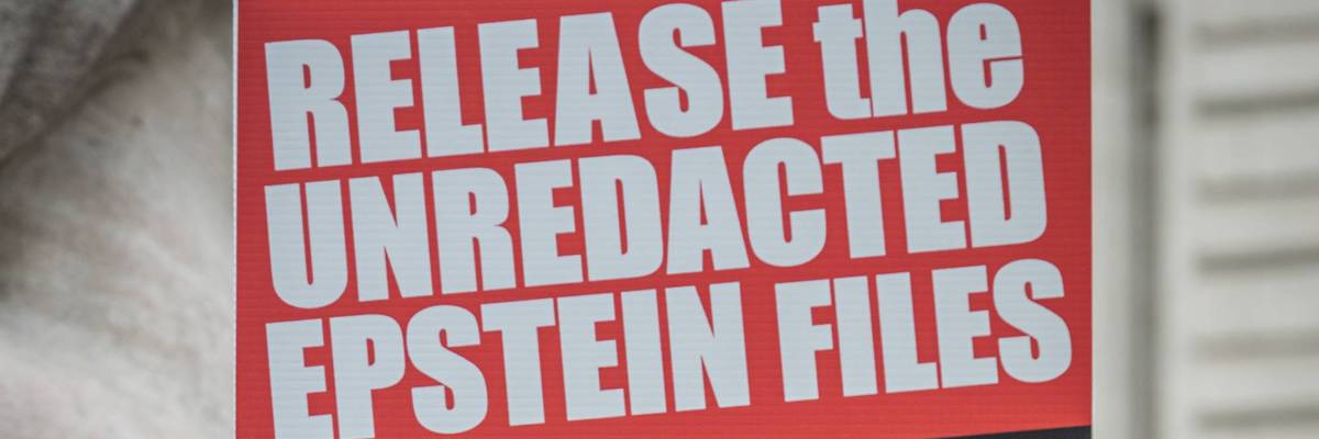 sign says, release the unredacted epstein files