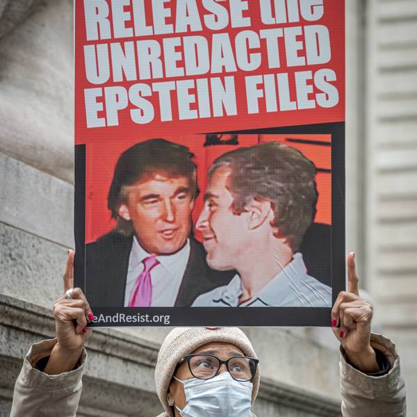 sign says, release the unredacted epstein files