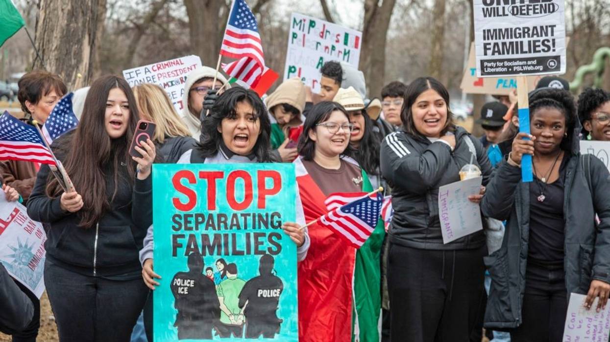 sign says, "Stop separating families"