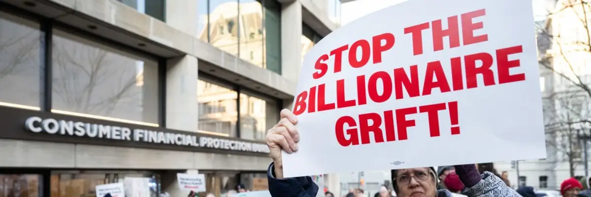 Sign says "Stop the billionaire grift"