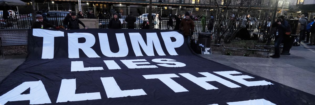 Sign says "Trump Lies All the Time:"