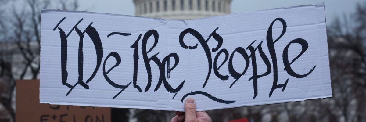 Sign says "We The People"