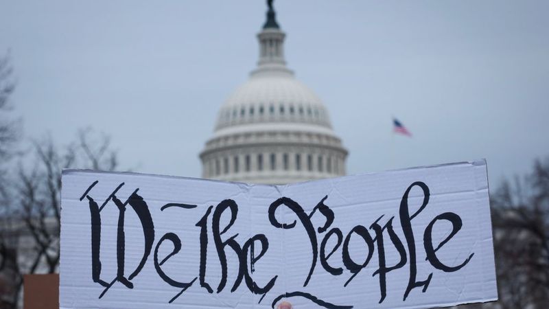 Sign says "We The People"