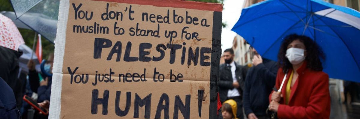 Sign says: "You don't need to be a Muslim to stand up for Palestine. You just need to be human."