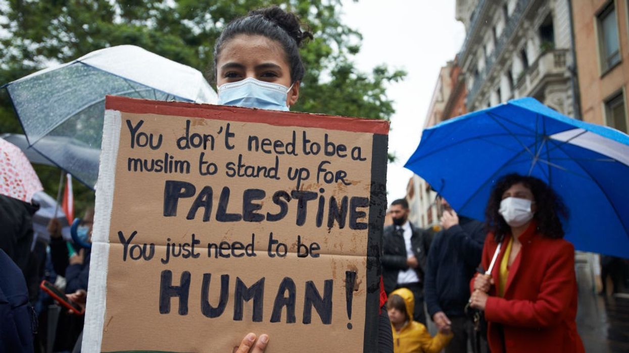 Sign says: "You don't need to be a Muslim to stand up for Palestine. You just need to be human."