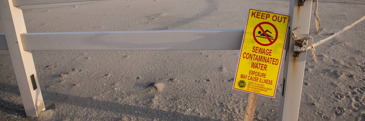 Sign warning of sewage from Tijuana River.