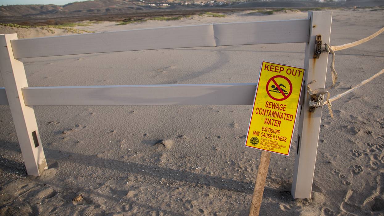 Sign warning of sewage from Tijuana River.