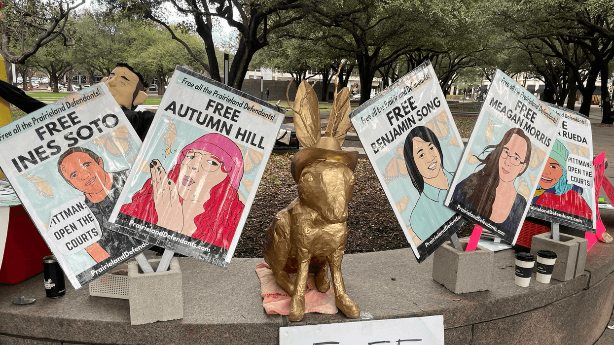 Signs call for the release of the Prairieland Detention Center protesters