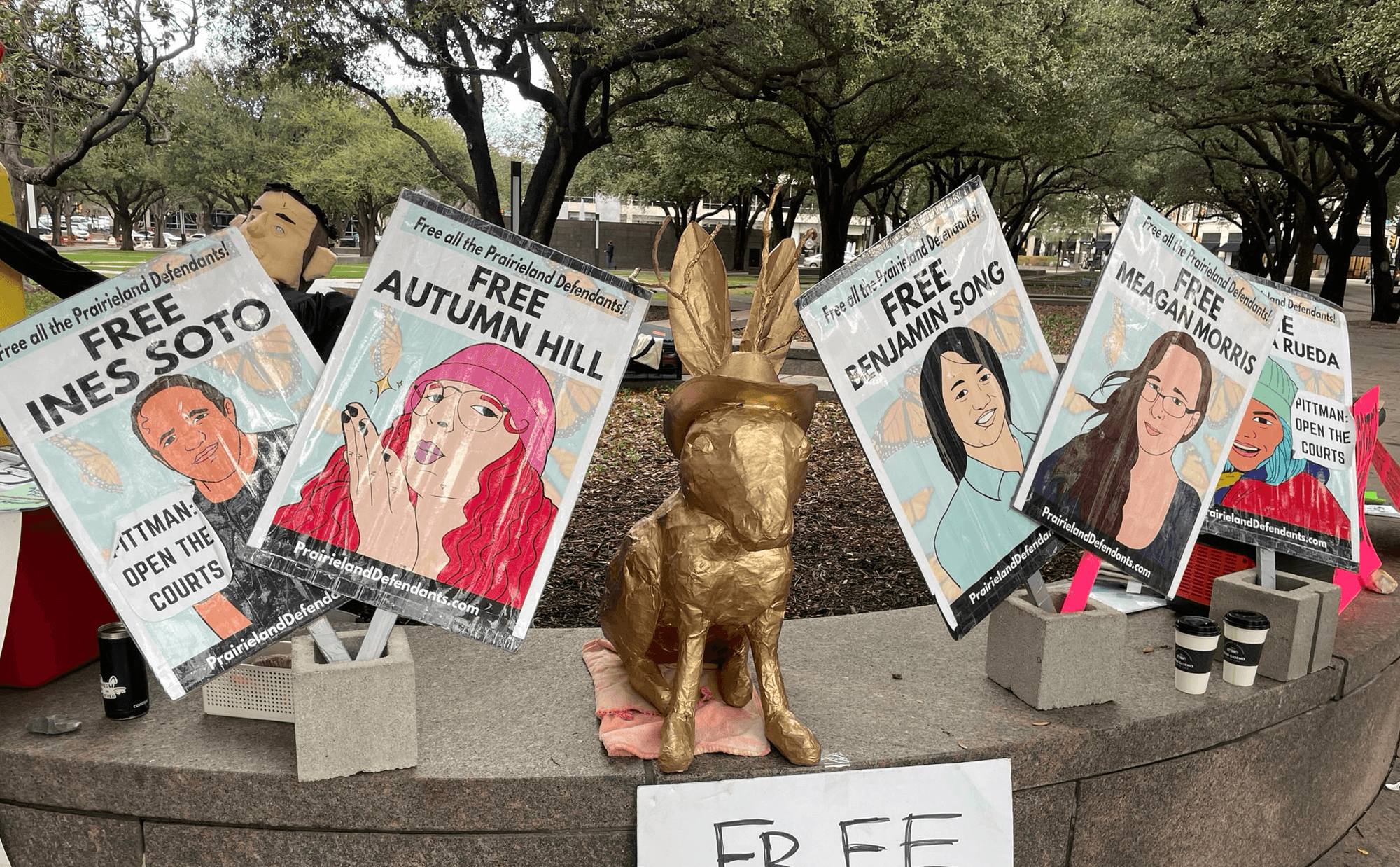 Signs call for the release of the Prairieland Detention Center protesters