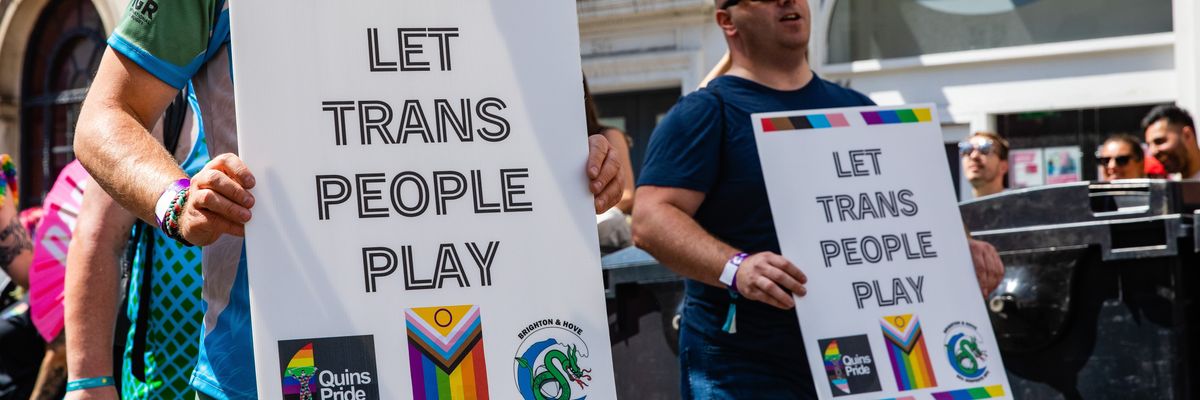 Signs calling for trans participation in sports.