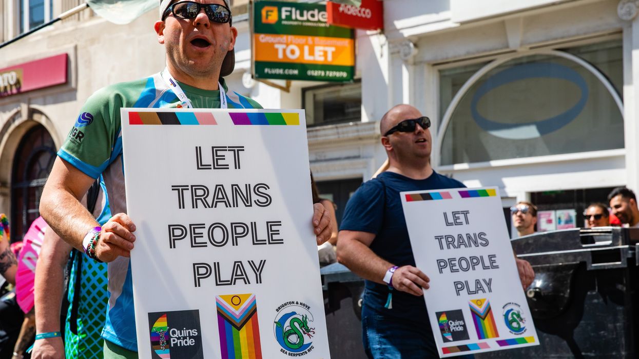 Signs calling for trans participation in sports.