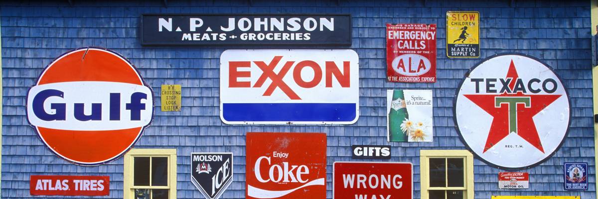 Signs on the side of a gas and service station. One of them says "Exxon."