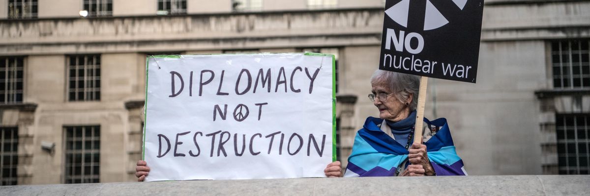Signs read "Diplomacy Not Destruction" and "No Nuclear War"