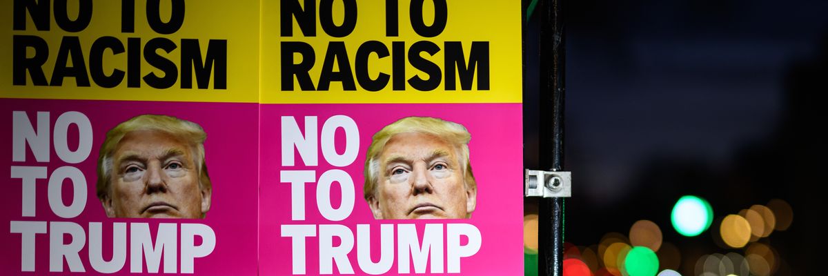 Signs read "No to Racism No to Trump."