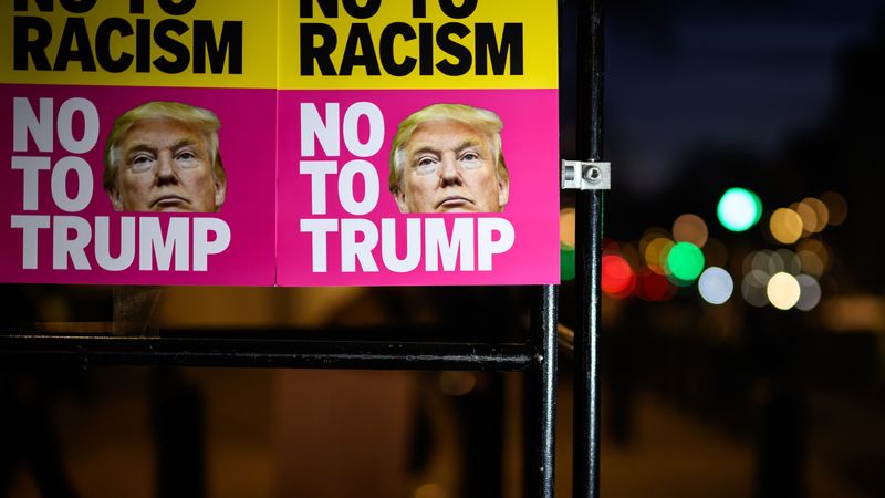 Signs read "No to Racism No to Trump."