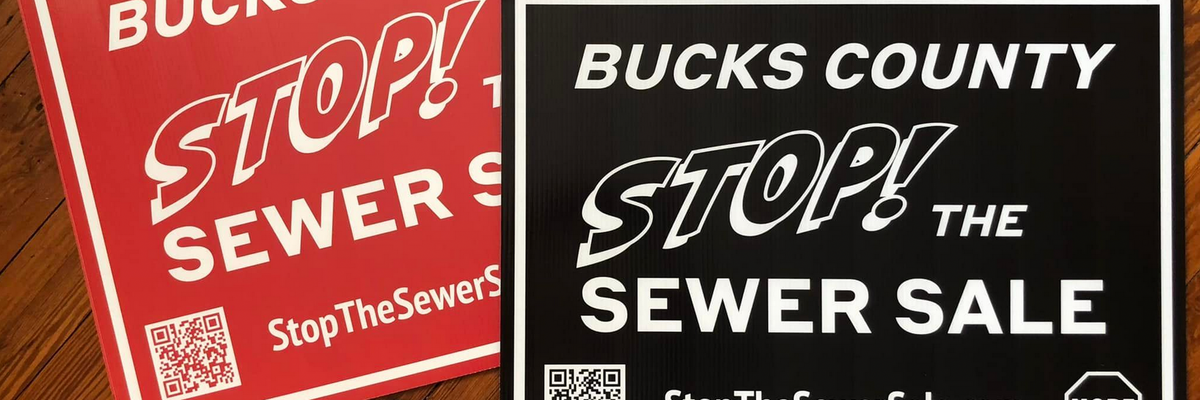 Signs reading, "Bucks County Stop the Sewer Sale"