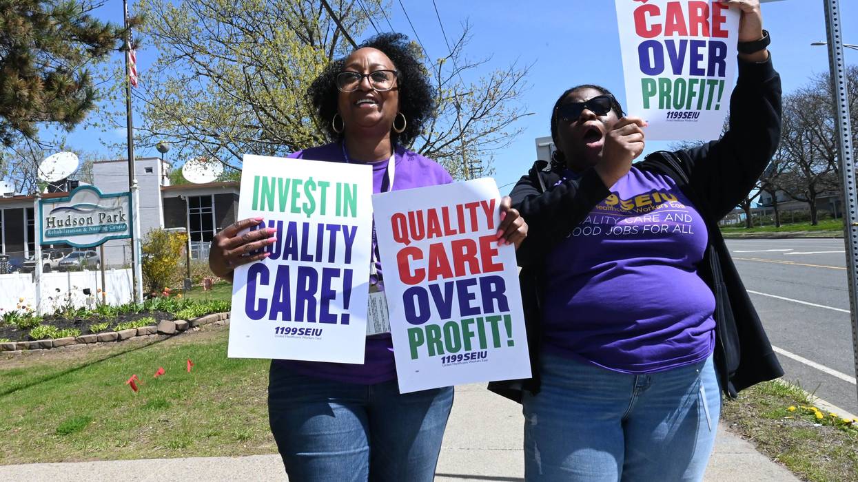 Signs say: "Quality Care Over Profits"